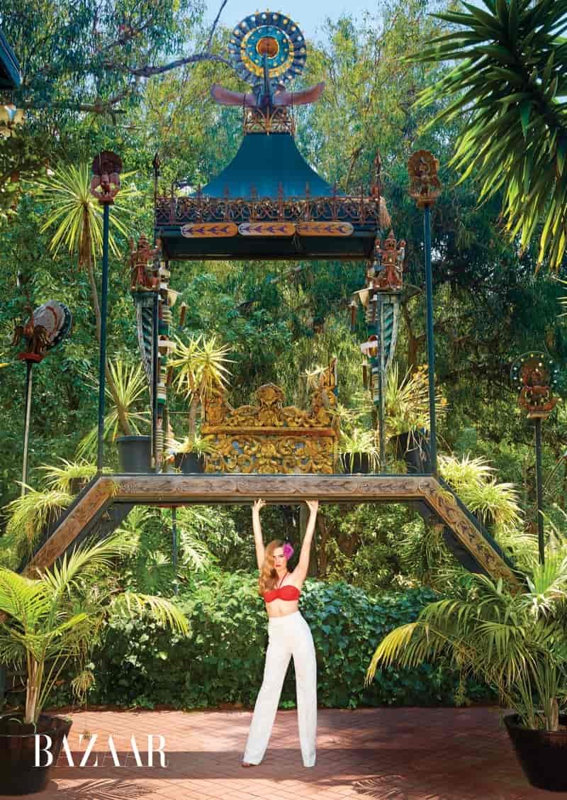 Zoey Deutch serves tropical vibes in Hermes bikini top and Bally high-waist pants