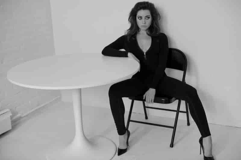 Aubrey Plaza strikes a pose in a Lacoste catsuit with Christian Louboutin pumps.