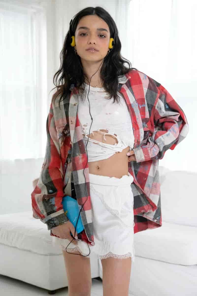 Rachel Zegler wears flannel plaid look.